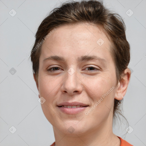 Joyful white young-adult female with short  brown hair and grey eyes