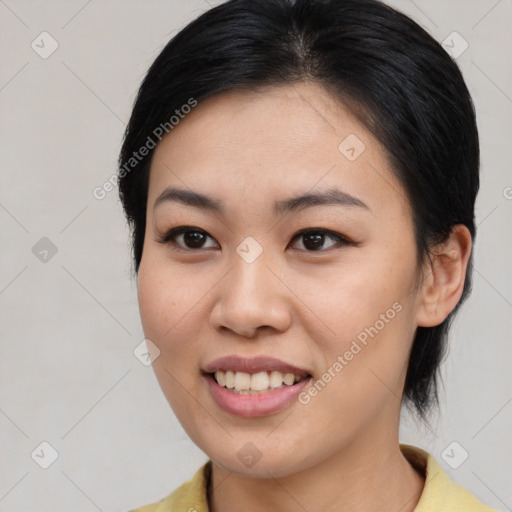 Joyful asian young-adult female with medium  black hair and brown eyes