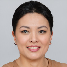 Joyful asian young-adult female with short  brown hair and brown eyes