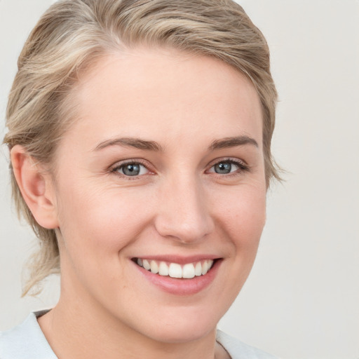 Joyful white young-adult female with medium  brown hair and blue eyes