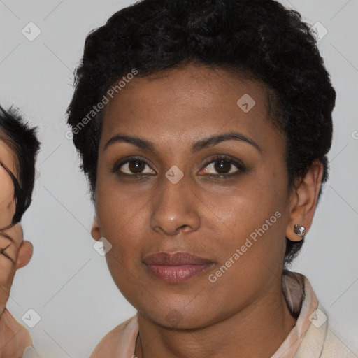 Joyful black young-adult female with short  brown hair and brown eyes