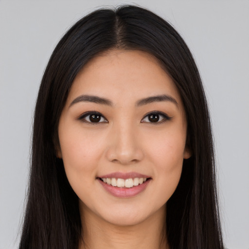 Joyful latino young-adult female with long  brown hair and brown eyes