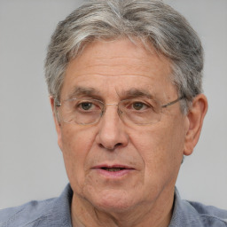 Joyful white middle-aged male with short  gray hair and brown eyes