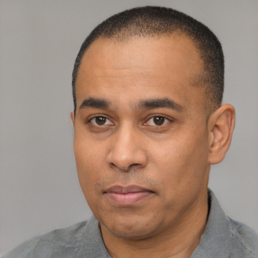 Neutral latino adult male with short  black hair and brown eyes