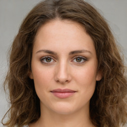 Joyful white young-adult female with long  brown hair and green eyes