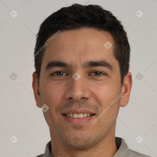 Joyful white young-adult male with short  black hair and brown eyes