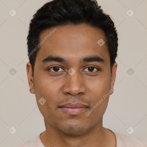 Joyful black young-adult male with short  black hair and brown eyes