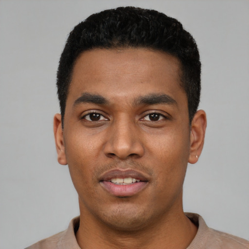 Joyful latino young-adult male with short  black hair and brown eyes
