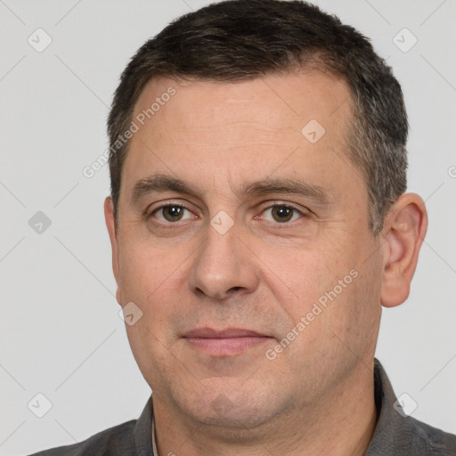 Joyful white adult male with short  brown hair and brown eyes