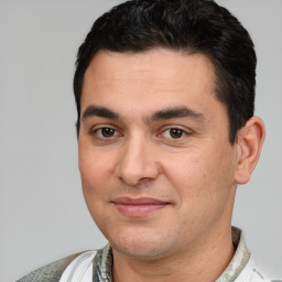 Joyful white young-adult male with short  black hair and brown eyes