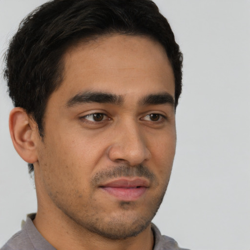 Neutral latino young-adult male with short  brown hair and brown eyes