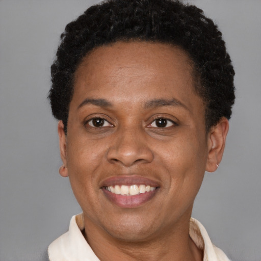 Joyful black adult female with short  black hair and brown eyes