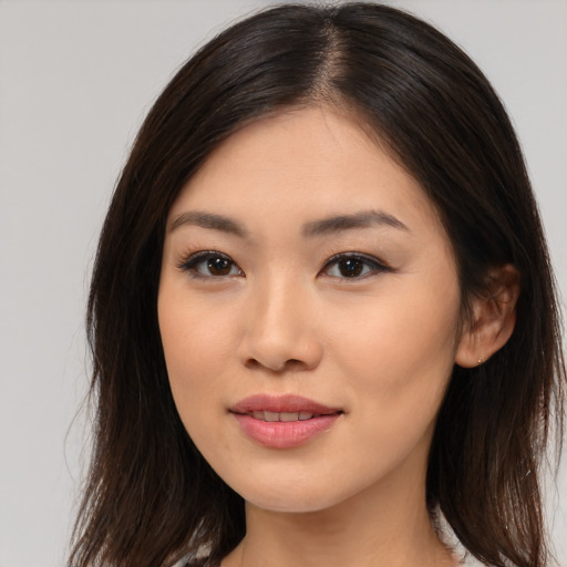 Joyful asian young-adult female with long  brown hair and brown eyes