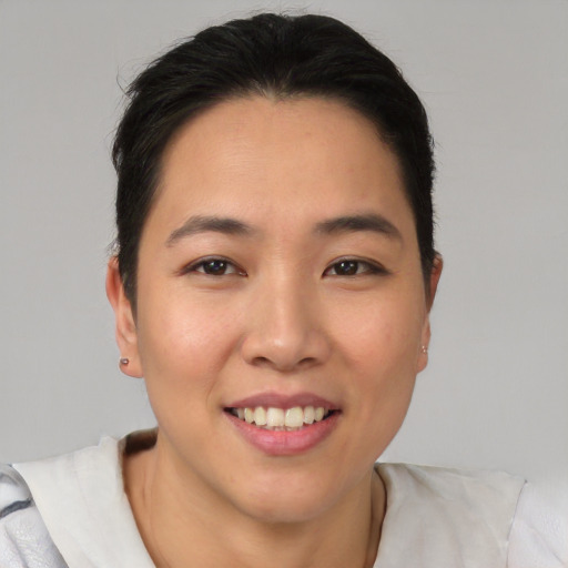 Joyful asian young-adult female with short  black hair and brown eyes