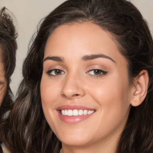 Joyful white young-adult female with long  brown hair and brown eyes