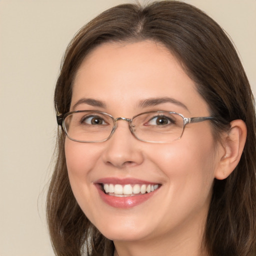 Joyful white adult female with long  brown hair and brown eyes