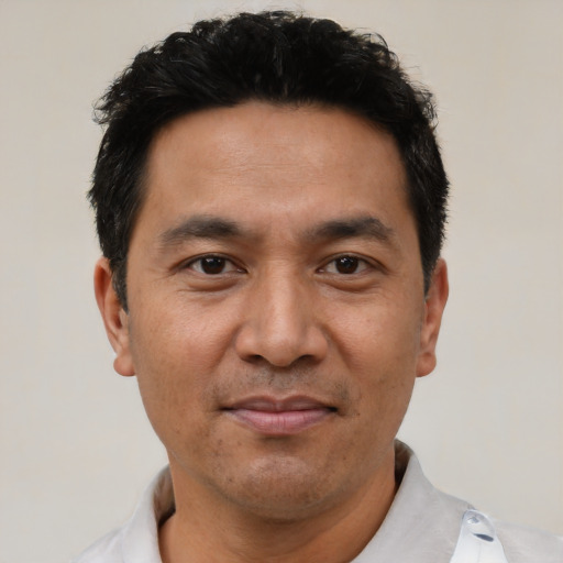 Joyful asian adult male with short  black hair and brown eyes