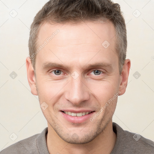 Joyful white adult male with short  brown hair and brown eyes