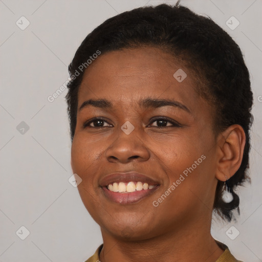 Joyful black young-adult female with short  brown hair and brown eyes