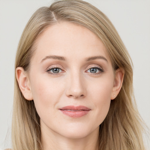 Joyful white young-adult female with long  brown hair and blue eyes