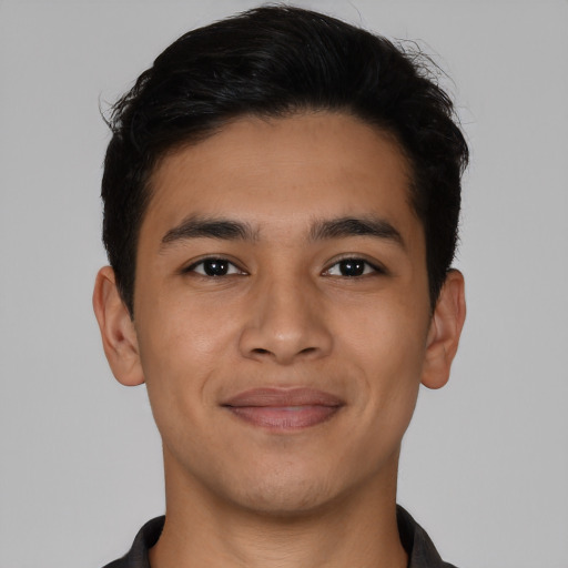 Joyful latino young-adult male with short  brown hair and brown eyes