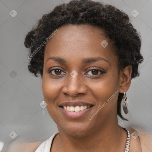 Joyful black young-adult female with short  brown hair and brown eyes