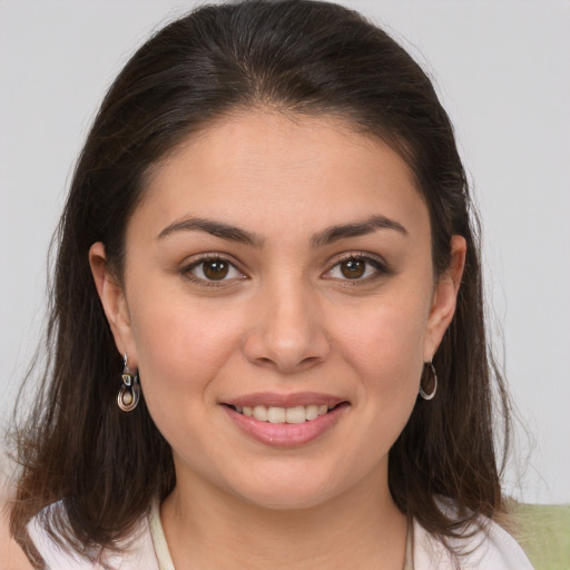 Joyful white young-adult female with medium  brown hair and brown eyes