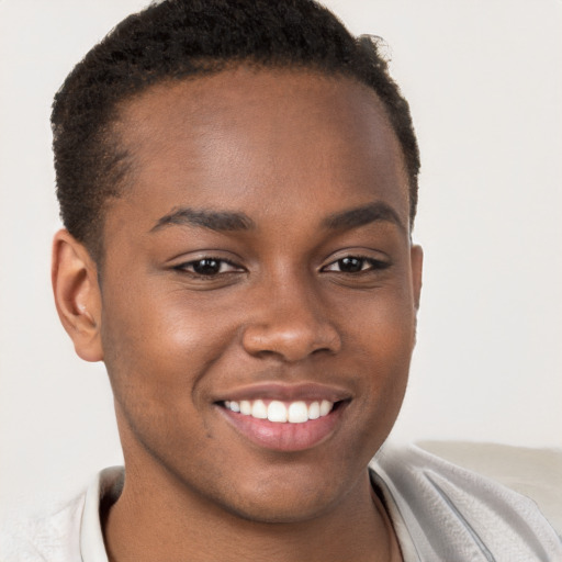 Joyful black young-adult male with short  brown hair and brown eyes