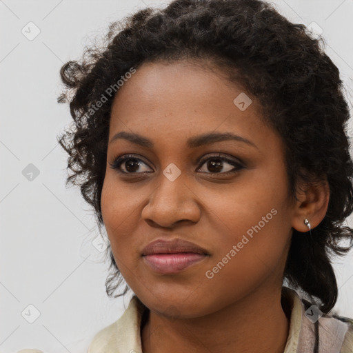 Joyful black young-adult female with long  black hair and brown eyes