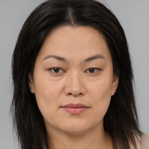 Joyful asian young-adult female with long  brown hair and brown eyes