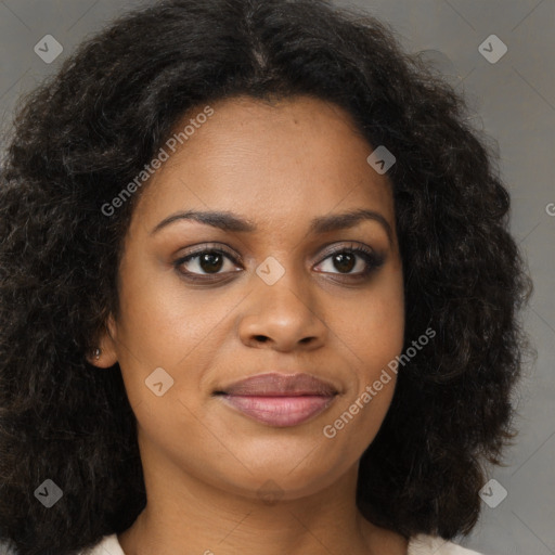 Joyful black young-adult female with long  brown hair and brown eyes