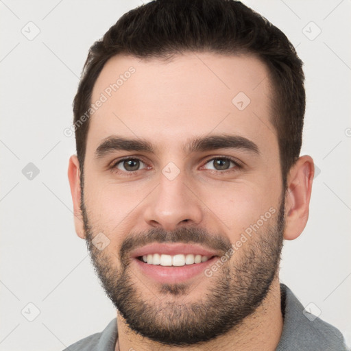 Joyful white young-adult male with short  brown hair and brown eyes