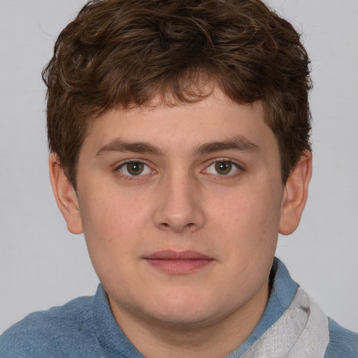 Joyful white young-adult male with short  brown hair and blue eyes