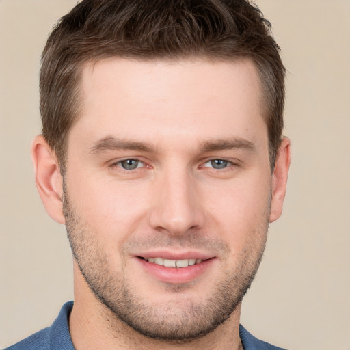 Joyful white young-adult male with short  brown hair and grey eyes