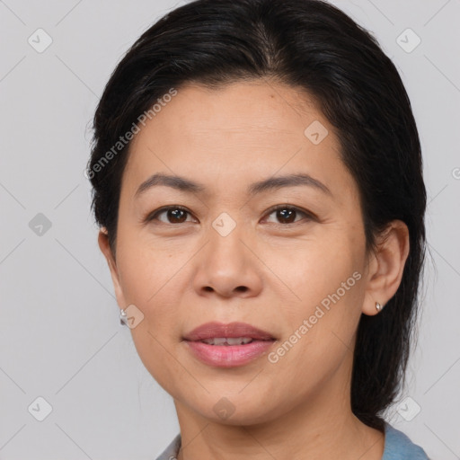 Joyful asian adult female with medium  brown hair and brown eyes