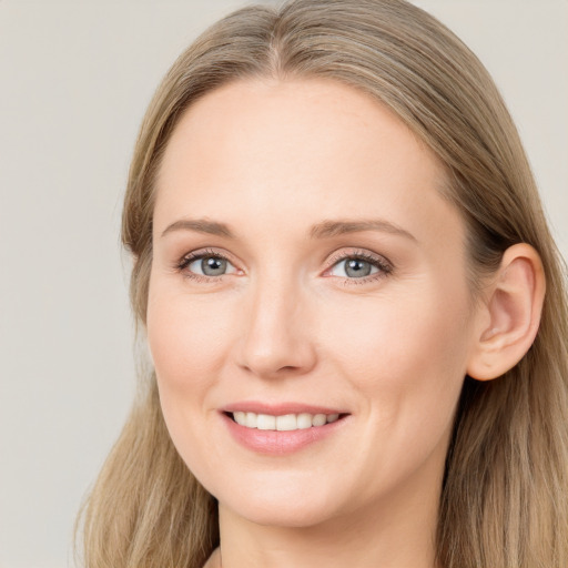 Joyful white young-adult female with long  brown hair and grey eyes