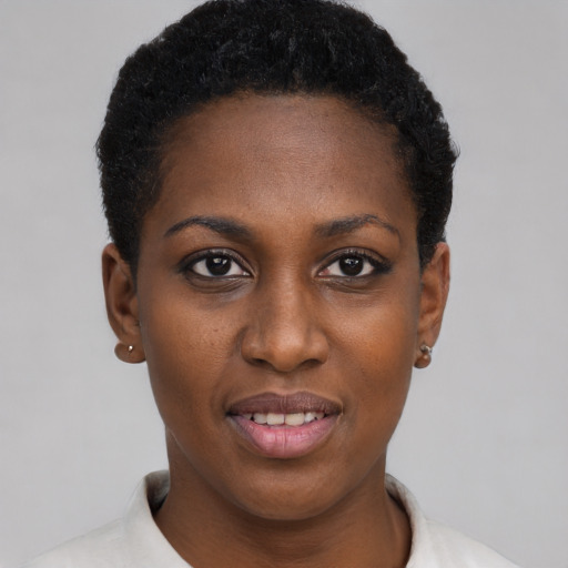Joyful black young-adult female with short  black hair and brown eyes