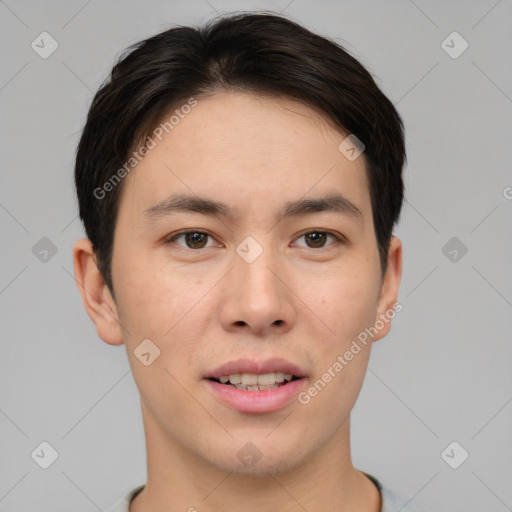 Joyful asian young-adult male with short  brown hair and brown eyes