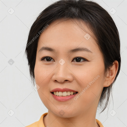 Joyful asian young-adult female with medium  brown hair and brown eyes