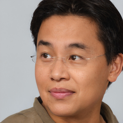 Joyful asian young-adult male with short  brown hair and brown eyes