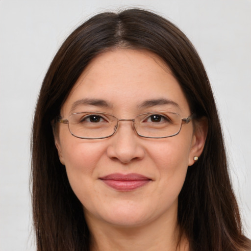 Joyful white adult female with long  brown hair and brown eyes