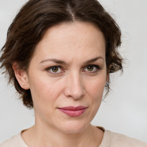 Joyful white young-adult female with medium  brown hair and green eyes