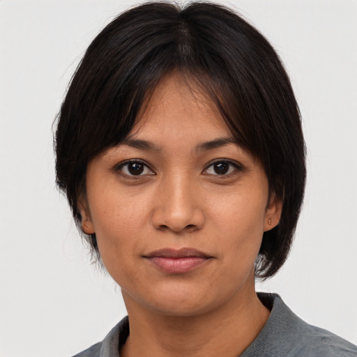 Joyful asian young-adult female with medium  black hair and brown eyes