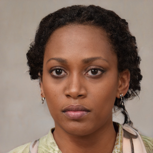 Neutral black young-adult female with medium  brown hair and brown eyes