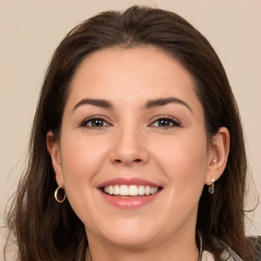 Joyful white young-adult female with long  brown hair and brown eyes