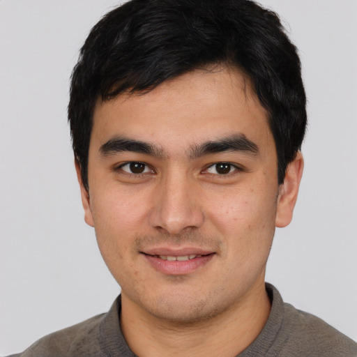 Joyful asian young-adult male with short  black hair and brown eyes