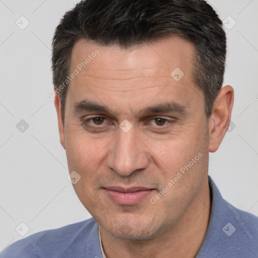 Joyful white adult male with short  brown hair and brown eyes