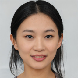 Joyful asian young-adult female with medium  black hair and brown eyes