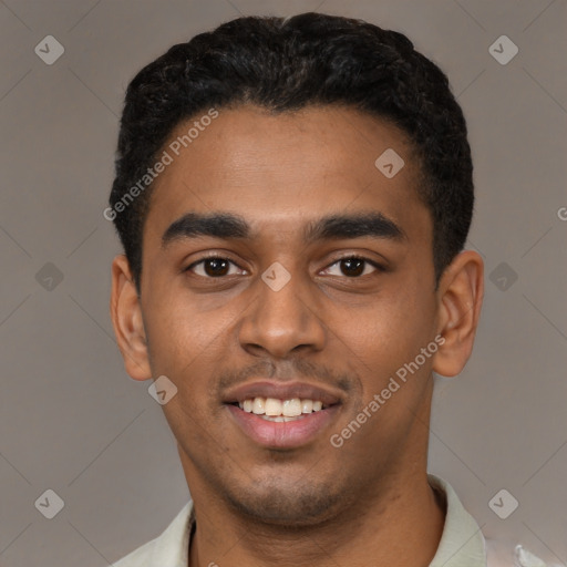 Joyful black young-adult male with short  black hair and brown eyes