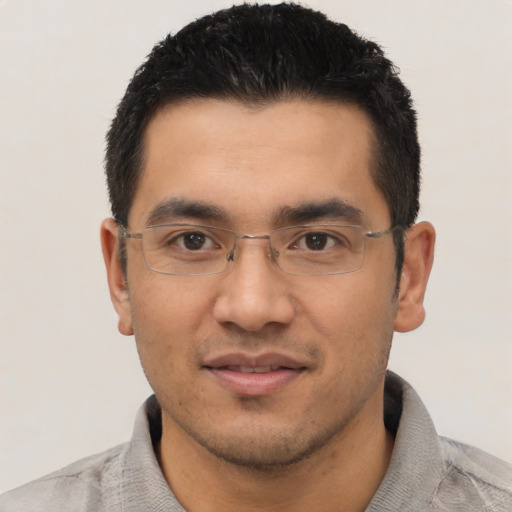 Joyful asian young-adult male with short  black hair and brown eyes